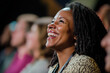 © frankb - Mid-aged black woman laughing in the audience of a show