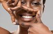 © Prostock-studio - Frame your smile. Beautiful african woman framing her perfect white teeth with fingers, closeup