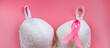 © Galina Atroshchenko - Breast Cancer Awareness Month. Women's bra and pink ribbon on bright background. Health care concept, oncology diagnostics. Cancer Fight Symbol.
