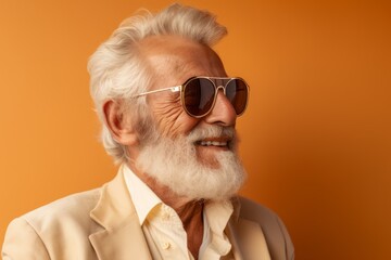 Wall Mural - Portrait of a tender elderly 100 years old man wearing a trendy sunglasses isolated in soft brown background