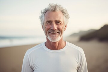 Sticker - Portrait of a happy afro-american man in his 60s sporting a long-sleeved thermal undershirt isolated in sandy beach background