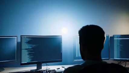 The camera zooms out from a brightly lit screen displaying a coding tutorial, revealing the programmer's silhouette.