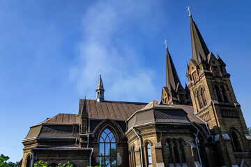 Gothic church architecture with spires and beautiful arched glass windows, Christian religion and culture. Color horizontal photo from bottom to top.