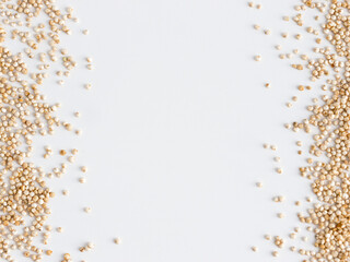 Wall Mural - Grain of real quinoa isolated on white background. Uncooked raw quinoa as background. Healthy vegan food concept and pattern. Copy space. Top view or flat lay.