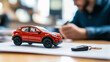 © Daniel Ernst - Rotes Auto - Konzept Finanzierung des ersten eigenen Autos