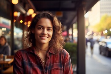 Poster - Portrait of a grinning woman in her 30s dressed in a relaxed flannel shirt isolated on bustling restaurant background