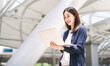 © dodotone - Business freelance adult asian woman using laptop standing at outdoor on day