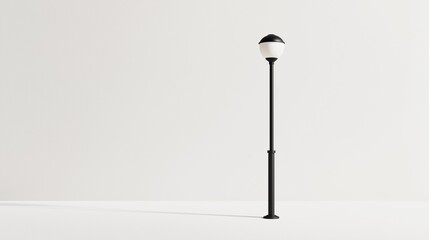 A solitary street lamp stands against a plain white wall, casting a faint shadow on the ground during daylight hours.