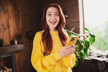 Sticker - Portrait of nice young girl open mouth hold smart phone wear yellow sweater loft interior flat indoors