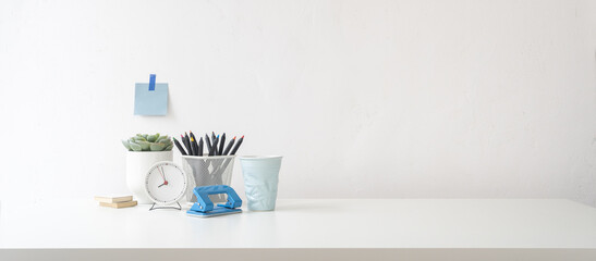 Wall Mural - Office table, empty desk with supplies and white wall copy space.	
