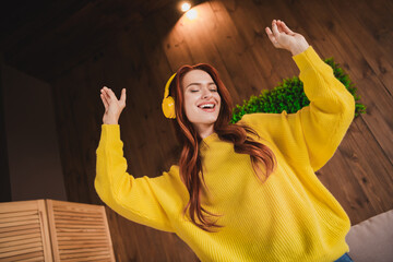 Sticker - Portrait of nice young girl dance headphones wear yellow sweater loft interior flat indoors