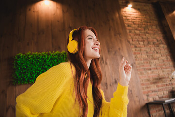 Sticker - Portrait of nice young girl dancing listen music wear yellow sweater loft interior flat indoors