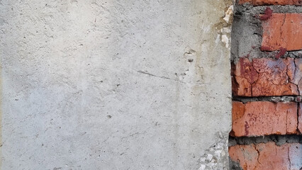 Close-up of concrete and brick wall. Cracks in the wall. Selective focus