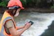 © reewungjunerr - Asian Female engineering working . at sewage treatment plant,Marine biologist analysing water test results,World environment day concept