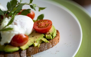 Avocado toast poached egg. Sliced avocado, poached egg, and cherry tomatoes on toasted bread. Perfect for a healthy and delicious brunch.