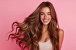 © MUdaylah - Beautiful woman with long wavy hair on a pink background. Ad for shampoo conditioner hair products .geneative ai