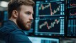 © justjupiter - Focused man analyzing stock market data on multiple screens in a modern office.