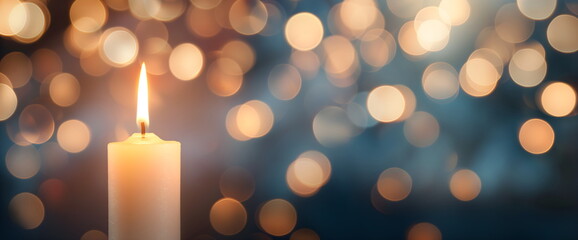 Glowing candle with bokeh lights for All Saints' Day remembrance and spiritual reflection