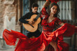 © Formoney - A woman in a red dress is dancing while a man plays a guitar