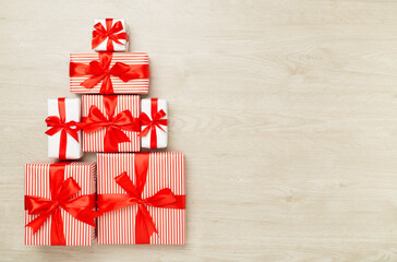 Wall Mural - Gift boxes in Christmas tree shape on wooden background, top view