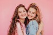 © Fotograf - Two friends embracing on a bright pink backdrop, perfect for friendship or love-themed projects