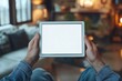 © kenkuza - Adult man using digital tablet with blank screen at home