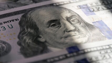 Close-up of a 100 dollar bill. The face of Benjamin Franklin. Macro