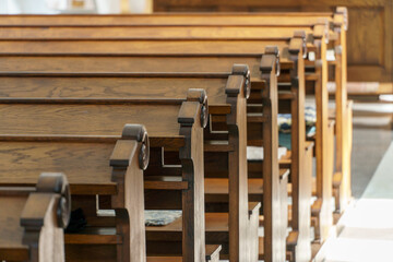 Wall Mural - Benches in the Catholic church. The interior of the church. Places for temple visitors to pray.