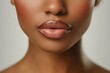 © Taras Vykhopen - Close-up of a beautiful Black woman's lips, showcasing perfect skin for skincare advertising