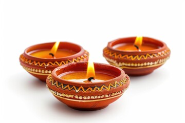 Poster - Three clay candles lit up on a white background, ideal for use in still life photography or as a decorative element