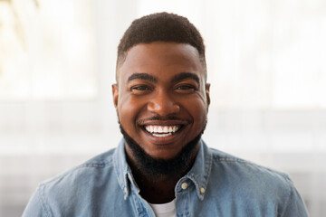 Wall Mural - Closeup portrait of handsome millennial african american guy with happy smile on face, copy space