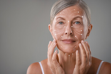 Poster - Beautiful woman with healthy skin on grey background. Arrows on face showing direction of massage moves