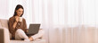 © Prostock-studio - Leisure Concept. Young woman relaxing at home on the couch, having coffee and using laptop computer, copyspace