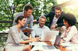 © JordaanExams/peopleimages.com - Laptop, business people and outdoor cafe with paperwork, teamwork and collaboration on balcony. Coffee shop, web and diversity with happy staff and chat with content creation planning and management