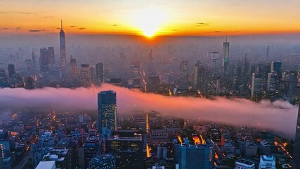 Poster - The vibrant sunset casts a warm glow over the city, highlighting skyscrapers and creating a stunning horizon filled with clouds and colors.