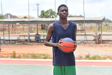 Picture of young focused african basketball player practicing outdoor. Fit afro man in motion and movement. athletic and sport lifestyle concept