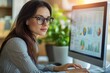 © Nognapas - Adult businesswoman working at home using computer, studying business ideas on a pc screen on-line.