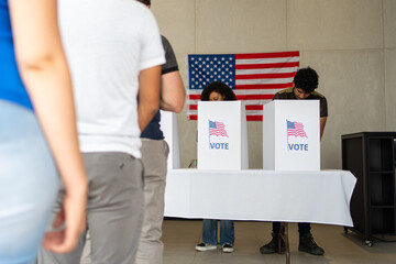 diverse group of people waiting in line queue for voting registration in the US election polling place