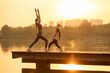 © Blue Jean Images - Mom And Daughter Doing Yoga In A Park