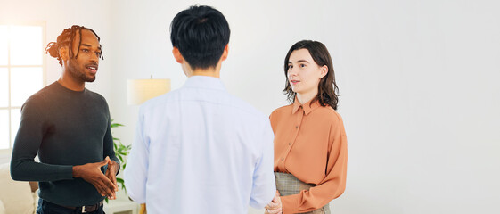 Poster - Multinational people standing and talking in an office