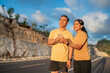 © Odua Images - smiling athletic couple using phone during jogging on the road