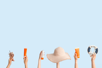 Sticker - Many hands with travel equipment and sunscreen cream on blue background