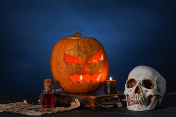 Poster - Halloween composition with jack-o-lantern, human skull, spell book and bottle of poison on table near blue wall