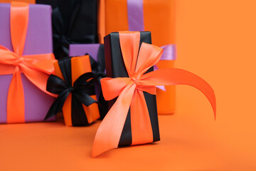 Different Halloween gift boxes on orange background