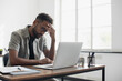 © kite_rin - Stressed business man sitting at office workplace. Tired and overworked student man. Young exhausted men in stress working on laptop computer