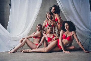 Canvas Print - Full body no retouch photo of charming models posing lying floor in studio with concrete wall background silky curtains