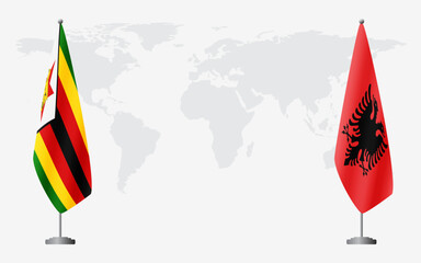 Zimbabwe and Albania flags for official meeting against background of world map.