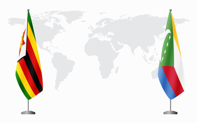 Zimbabwe and Comoros flags for official meeting against background of world map.