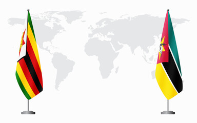 Zimbabwe and Mozambique flags for official meeting against background of world map.