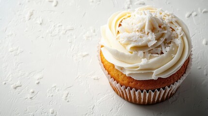 Wall Mural - Delicious coconut cupcake topped with creamy frosting and shredded coconut, perfect for dessert lovers and baking enthusiasts, background with copy space